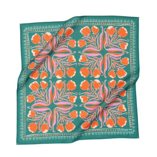 Floral patterned scarf with orange flowers on a green background