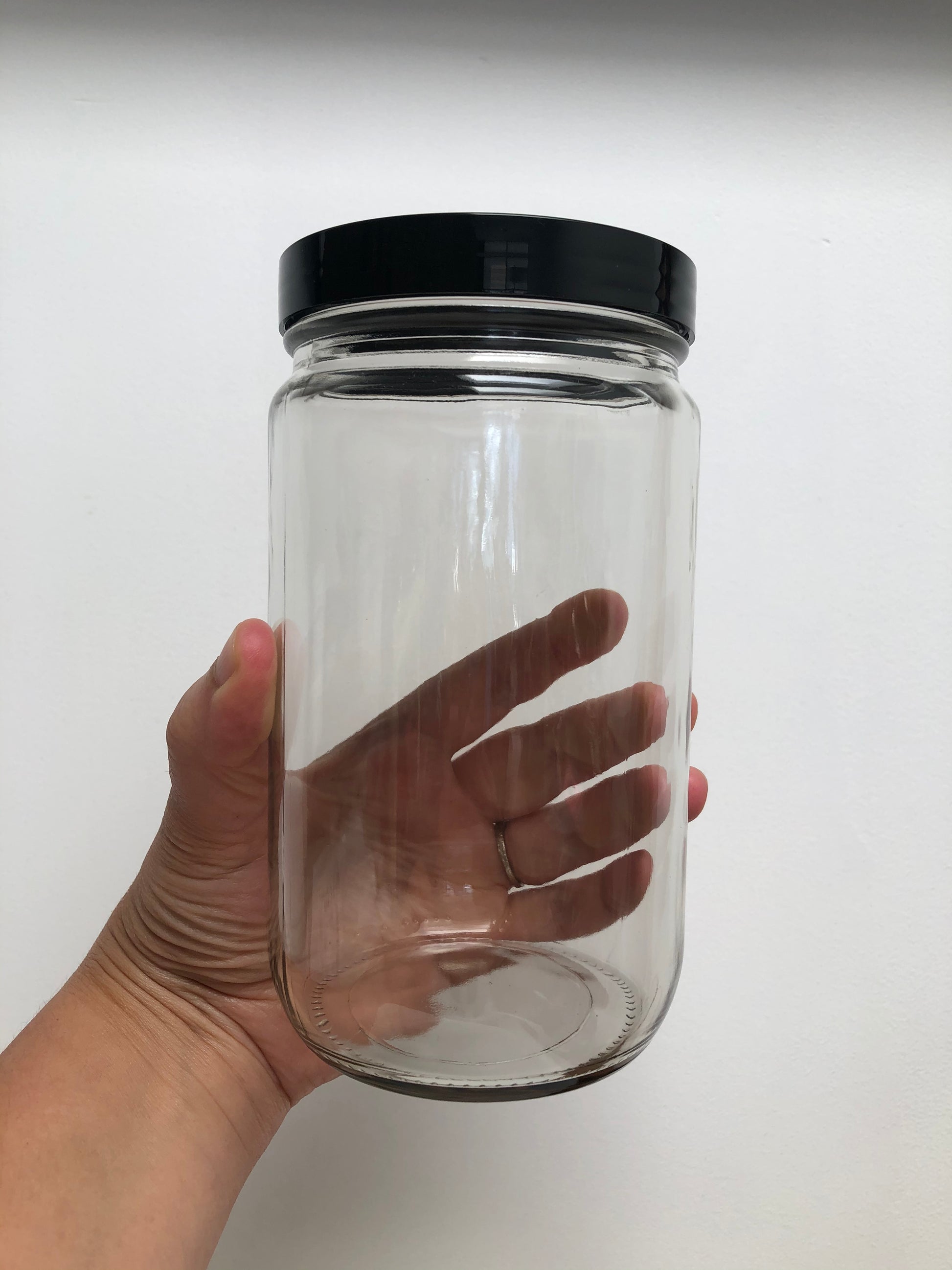 32 ounce clear glass jar with black plastic lid, shown as a container option