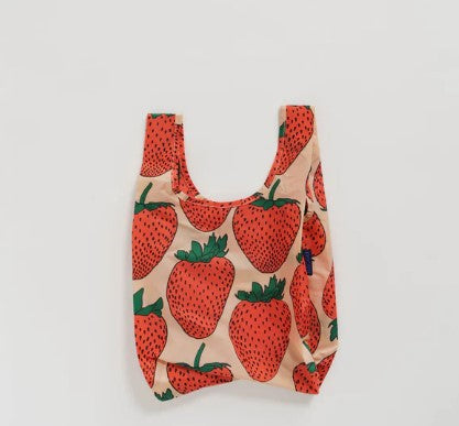 White background with nylon baby baggu bag laying flat to show pink and red strawberry pattern